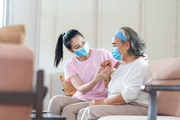 young lady talking to old lady