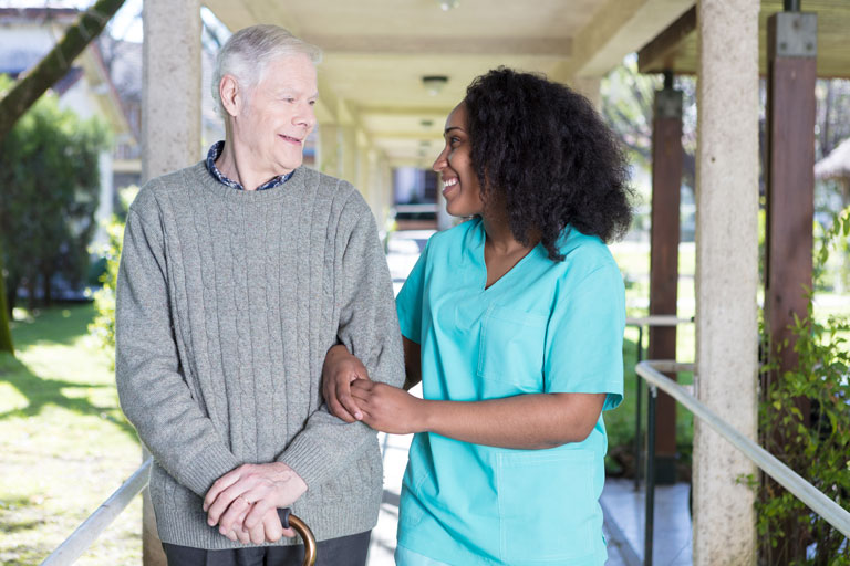 young lady assisting old man