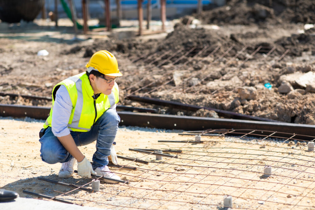 asian-construction-worker-building-site-fabricating-steel-reinforcement-bar